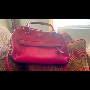 Red Kate Spade with a removable long strap and a short shoulder strap.